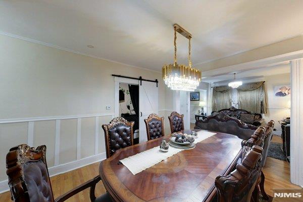 dining room featuring a barn door and hardwood / wood-style floors