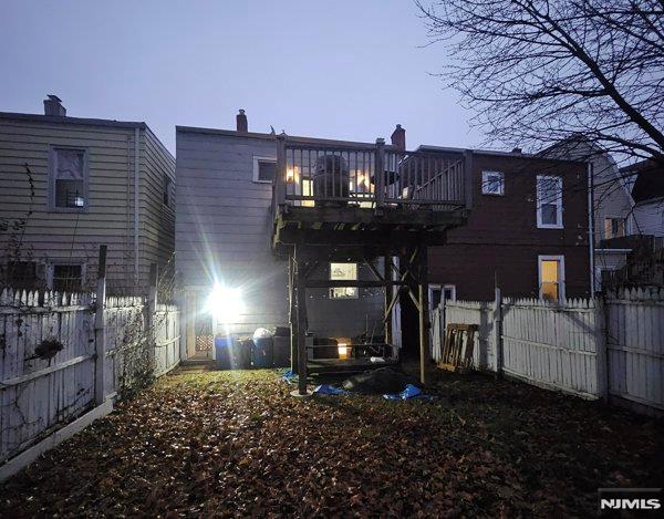 view of back house at dusk