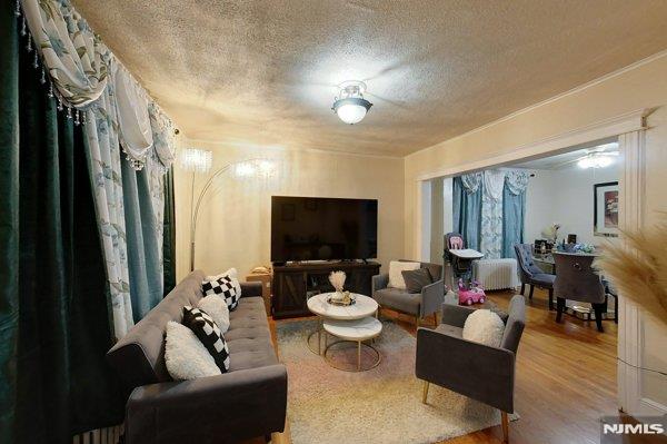 living room featuring hardwood / wood-style floors and a textured ceiling