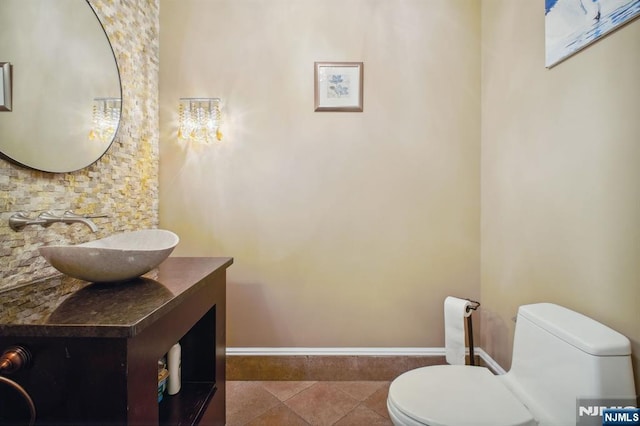 bathroom featuring vanity, tile patterned floors, and toilet