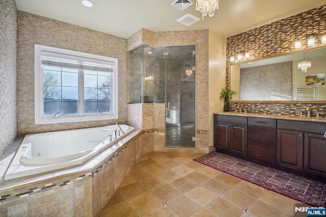 bathroom with vanity, tasteful backsplash, shower with separate bathtub, and a chandelier