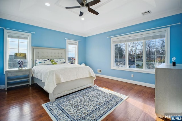 bedroom featuring ceiling fan, a tray ceiling, and dark hardwood / wood-style flooring