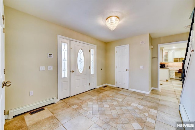 tiled foyer entrance featuring baseboard heating