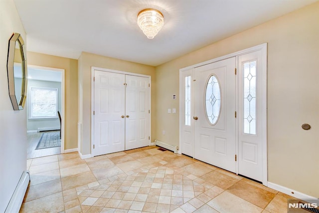 tiled entryway with a baseboard heating unit