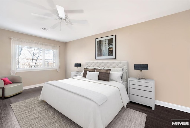 bedroom with ceiling fan and dark hardwood / wood-style floors