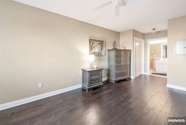 unfurnished bedroom featuring ensuite bathroom, ceiling fan, and dark hardwood / wood-style floors