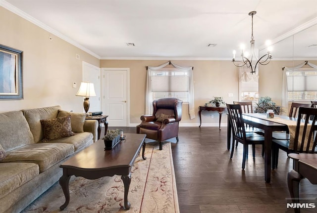 living room featuring dark wood-type flooring, an inviting chandelier, and ornamental molding