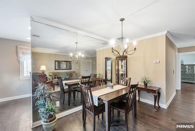 dining room featuring a notable chandelier, crown molding, and dark hardwood / wood-style floors