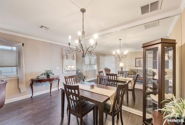 dining area featuring dark wood-type flooring, crown molding, and an inviting chandelier