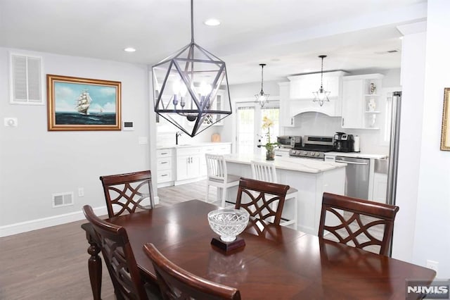 dining room featuring hardwood / wood-style floors and sink