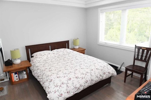 bedroom with dark wood-type flooring