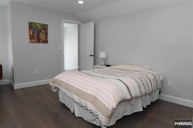 bedroom featuring lofted ceiling and dark hardwood / wood-style floors