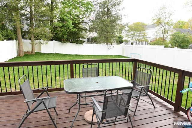 wooden terrace featuring a yard