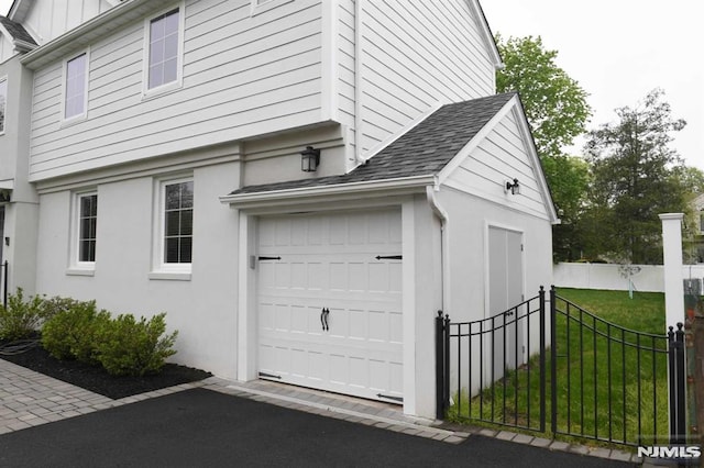 view of side of property featuring a yard and a garage