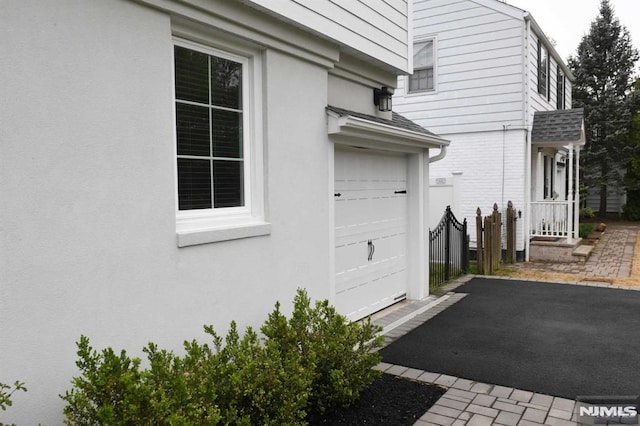 view of side of home featuring a garage