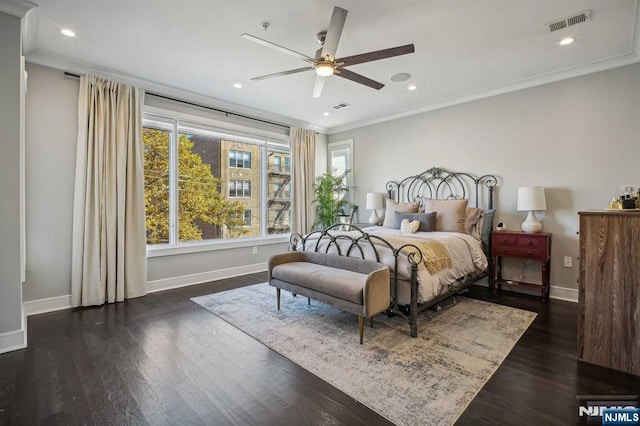 bedroom with dark hardwood / wood-style flooring, crown molding, and ceiling fan