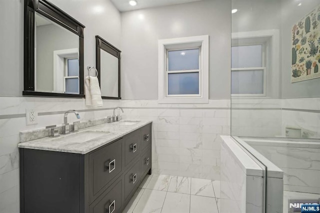 bathroom with vanity and tile walls