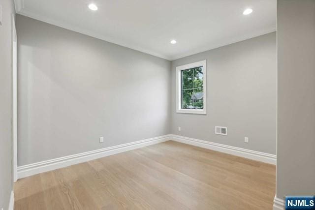 empty room with light hardwood / wood-style flooring