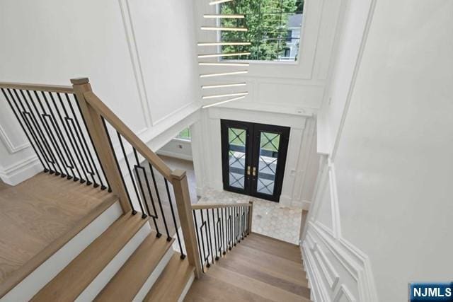 entryway featuring light hardwood / wood-style flooring and french doors