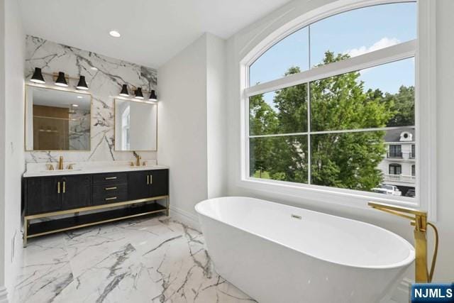 bathroom featuring vanity and separate shower and tub