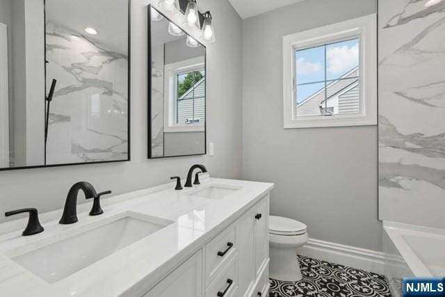 bathroom featuring vanity and toilet