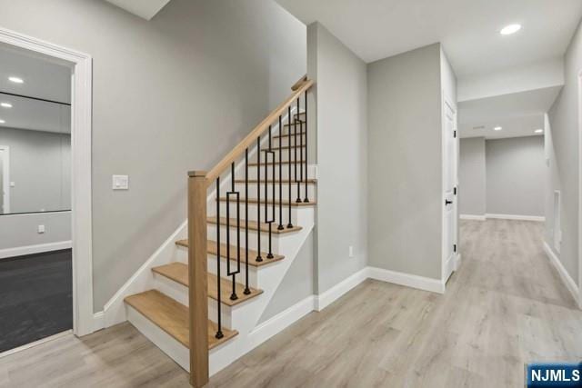 stairs featuring wood-type flooring