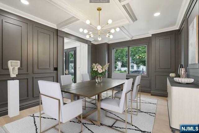 dining space featuring crown molding, an inviting chandelier, and light hardwood / wood-style floors