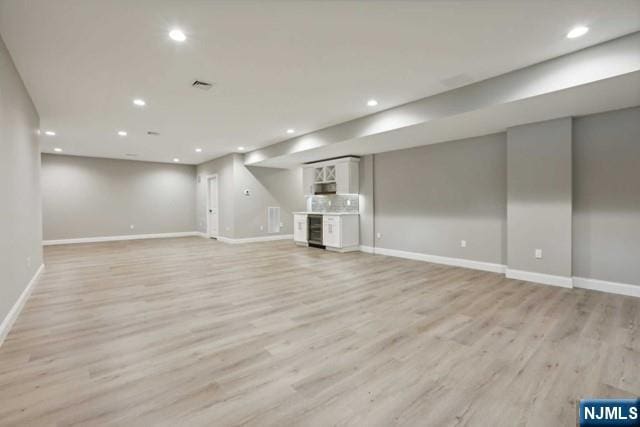 basement featuring light hardwood / wood-style flooring