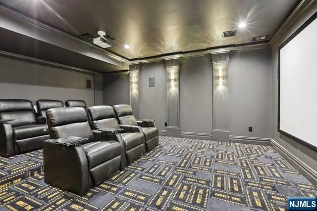 carpeted cinema room with crown molding