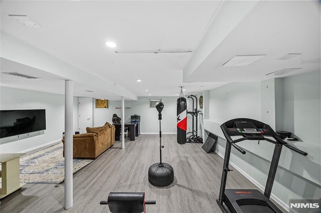 exercise area with light hardwood / wood-style flooring