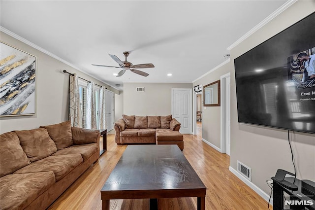 living room with light hardwood / wood-style flooring, ceiling fan, and ornamental molding