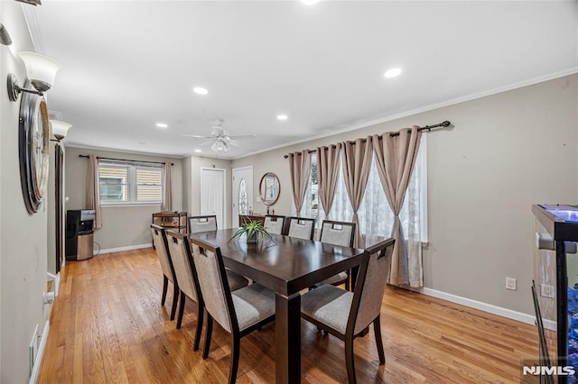 dining space featuring crown molding, light hardwood / wood-style floors, and ceiling fan