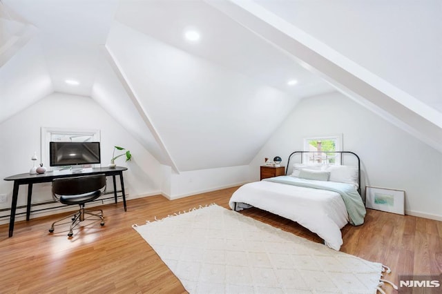 bedroom featuring hardwood / wood-style flooring and lofted ceiling