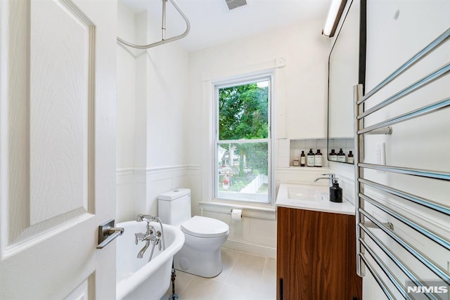 bathroom featuring toilet, a bath, tile patterned flooring, and vanity