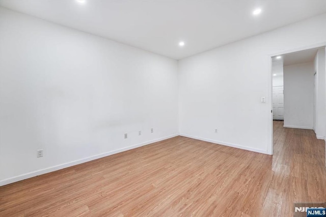 empty room with light hardwood / wood-style floors