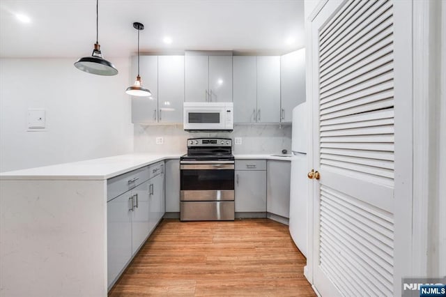 kitchen with pendant lighting, gray cabinets, stainless steel range with electric cooktop, and light wood-type flooring