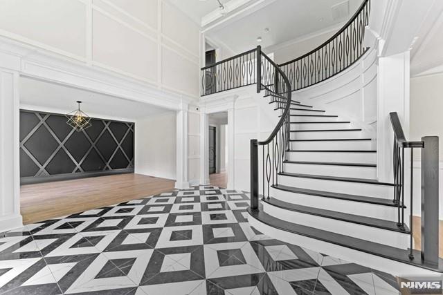 entrance foyer with a towering ceiling and ornate columns