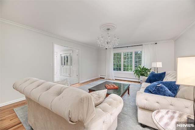 living room featuring ornamental molding, hardwood / wood-style flooring, a baseboard radiator, and an inviting chandelier