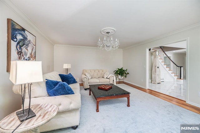 living room featuring a chandelier, ornamental molding, and hardwood / wood-style floors