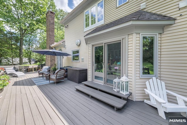 wooden terrace with an outdoor hangout area