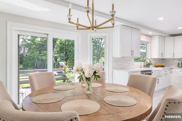 dining area featuring sink and a chandelier