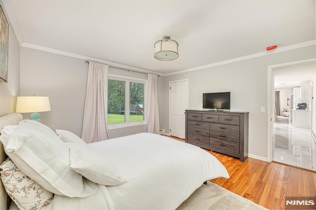 bedroom featuring crown molding and wood-type flooring