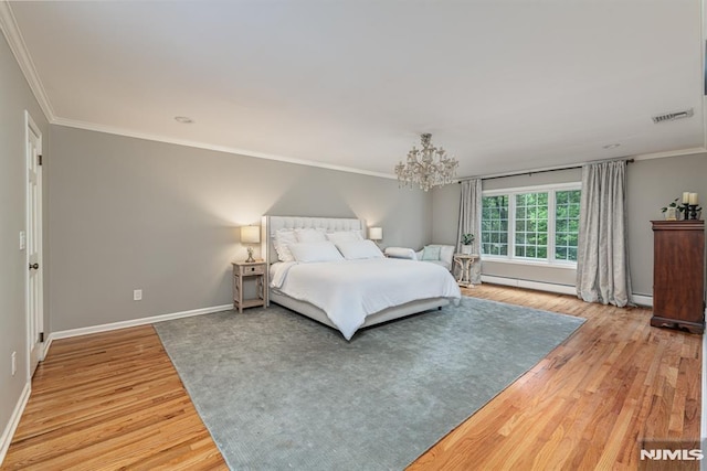 bedroom with a baseboard radiator, hardwood / wood-style floors, and ornamental molding