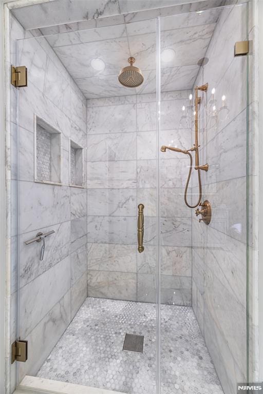 bathroom with a shower with shower door