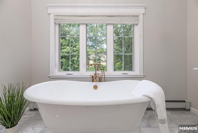 bathroom featuring a tub and a baseboard heating unit