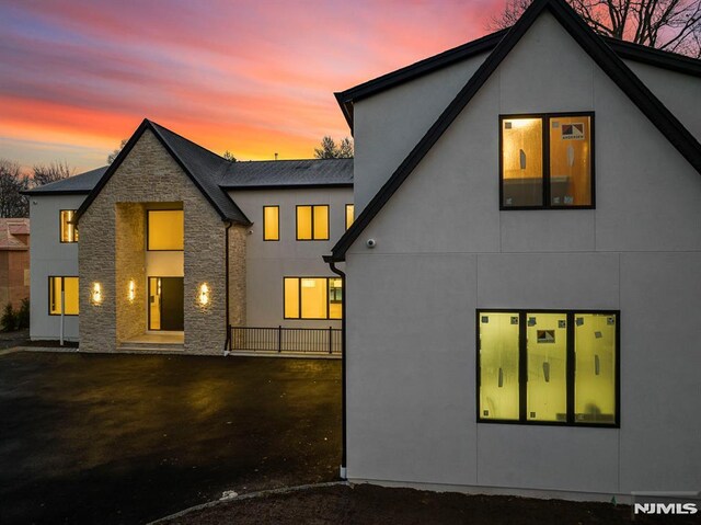 view of back house at dusk