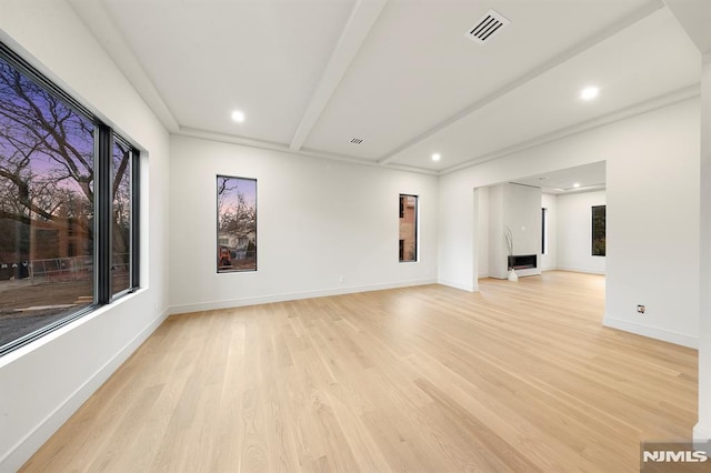 interior space with beamed ceiling and light hardwood / wood-style flooring