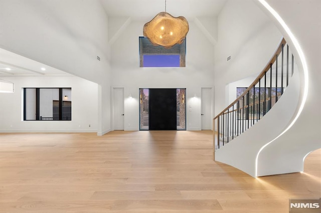 entryway featuring light hardwood / wood-style floors and a high ceiling