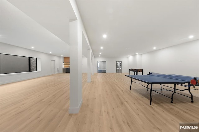 rec room with light hardwood / wood-style flooring