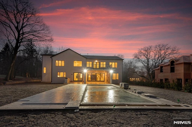 view of front of property with a patio and a balcony